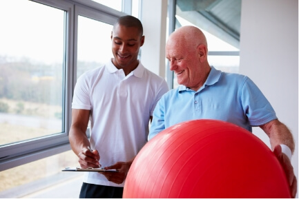 https://lp-physicaltherapy.com/wp-content/uploads/2019/01/therapist-with-patient-holding-swiss-ball.jpg